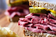 a corned beef sandwich on rye bread with pickles