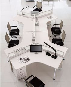 an office cubicle with several chairs and desks