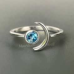 "Blue Topaz Crescent Moon Ring, Minimalist Ring, 925 Sterling Silver Statement Adjustable Ring, Blue Topaz Ring, Birthstone Ring Gift For Her SHOP LINK:- https://www.etsy.com/shop/MaaShabashibaJewell?ref=seller-platform-mcnav 》D E T A I L S《 Gemstone: Natural Blue Topaz Gem Color: Blue Gem Shape: Round Metal: 925 Sterling Silver Purity: 925 Parts Per 1000 Setting Type: Bezel Set Silver Polish: High Ring Size: All Size Available Please note that there Can be slight variations in stone texture and Blue Minimalist Sterling Silver Stackable Rings, Minimalist Blue Sterling Silver Stackable Rings, Blue Minimalist Stackable Sterling Silver Rings, Minimalist Blue Crystal Open Ring, Sterling Silver Moon Shaped Birthstone Rings, Minimalist Blue Crystal Birthstone Ring, Blue Moonstone Birthstone Ring In Sterling Silver, Blue Sterling Silver Open Birthstone Ring, Blue Sterling Silver Open Midi Rings