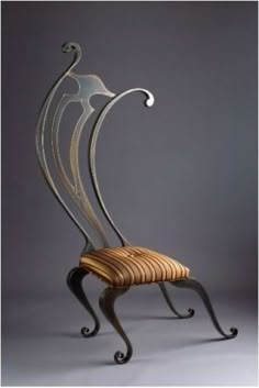 a chair that is made out of wood and metal with an intricate design on the back