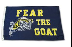 a flag that says fear the goat with a yellow and blue design on it's side