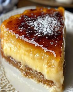 a piece of cake sitting on top of a white plate covered in powdered sugar