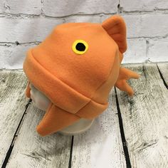 an orange stuffed animal with yellow eyes