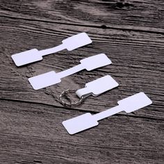 four pieces of white paper are sitting on a wooden surface