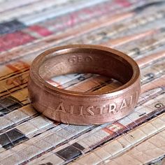 a close up of a coin ring on a table cloth with the word austral printed on it