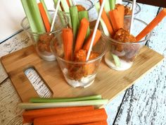 carrots and celery sticks are arranged on a cutting board