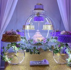 three tiered cake display with purple and gold decorations