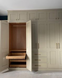 an empty closet with drawers and cupboards on the wall next to each other in a room