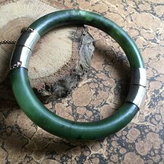 Bracelet is in good condition. Does show signs of wear. Nephrite Jade, Spinach green with 10k White gold closure. Closure looks gold when open. Chain is gold. Chinese markings on white gold portions but not sure what they depict. Closure tests as 10k gold. Unsigned Antique Green Jewelry With Polished Finish, Classic Green Bangle Jewelry, Vintage Jade Bangle, Nephrite Jade, Safety Chain, Jade Bracelet, 10k Gold, Spinach, Jade