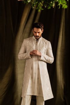 A luxurious, mid-thigh olive-gold toned kurta and pajama set with linear traditional motif embroidery detailed with tilla.   Color: Olive Gold Fabric: Cotton Luxe Blend  wajaj ali latest outfits, wahaj latest wardrobe, wahaj outfit 2024, Olive Embroidery, White Sherwani, Sherwani For Groom, Blue Sherwani, Beige Embroidery, Sherwani For Men Wedding, Nikah Dress, Sherwani Groom