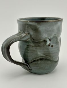 a green mug with a handle on a white background