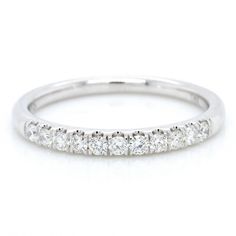 a white gold wedding band with five round diamonds on the top and bottom, set in 18k white gold