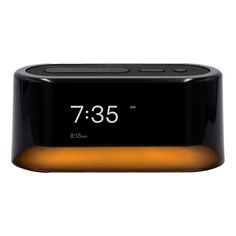 an alarm clock is shown with the time on it's display and orange light