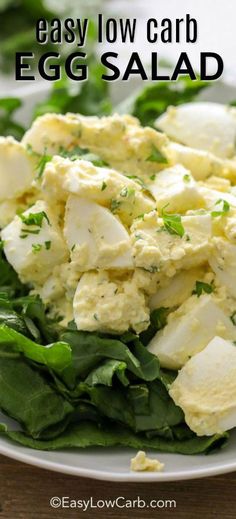 an egg salad on a white plate with lettuce