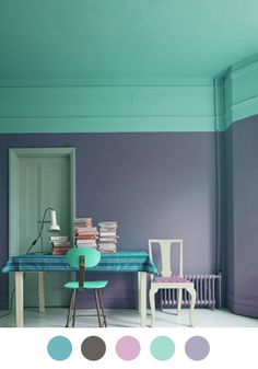 a room with two chairs and a table covered in books on top of the floor