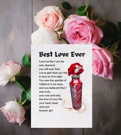 a card that says best love ever next to some pink roses on a wooden table