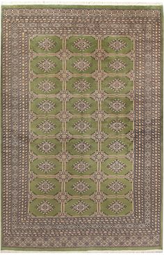 a green rug with an intricate design on the center and sides, in different colors