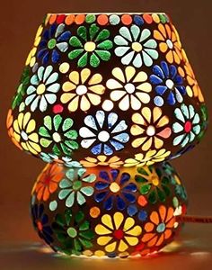 two colorful lamps sitting next to each other on a table