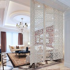 a room divider in the middle of a living room with chandelier hanging from the ceiling