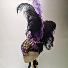 Couture showgirl headdress, featuring a central purple golden and purple jewel and mohawk with purple and black ostrich feathers. The ostrich feathers are removable for easy transport and storing of the headpiece. The base is in a deep purple velvet and gold fabric with sequinned applique' and rhinestones details.  Fringed with golden chain at the front head size 57.5 (please get in touch if you are not sure how to measure your head) The headdress has been completely hand-made in our studio in L Purple Costume Hats And Headpieces For Carnival Party, Black Carnival Costume Hats And Headpieces, Black Flapper Headpiece For Costume Party, Black Ostrich Feather Headpiece, Adjustable Purple Costume Accessories For Party, Black Ostrich Feather Trim Headpiece, Purple Mardi Gras Costume Accessories, Feathered Costume Hats And Headpieces For Mardi Gras, Feathered Hats And Headpieces For Mardi Gras Costume Party