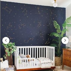 a baby's room with stars painted on the wall and a white crib