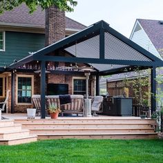 a patio with an attached grill and seating area