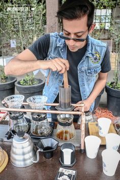 a man is making coffee at an outdoor cafe