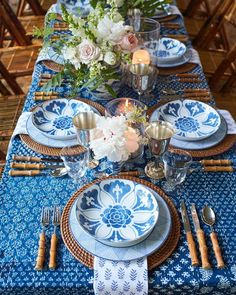 a table set with blue and white plates