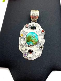 "ARTISAN TURQUOISE TOURMALINE PENDANT Hand-made Sterling Silver 925. Stones used: Turquoise(Nevada), Green Tourmaline, Pink Tourmaline, Red Sapphire, Citrine, Amethyst, Garnet. Height -2 3/4\" (including bail), Width - 1 6/16\" Height - 72mm (including bail), Width - 35mm Unique Handcrafted One-of a-kind Design Pendant Each Piece of Jewelry in my Collection is Absolutely One of a Kind! When you start wearing a piece of my jewelry you will fall in love with it more and more each day and feel that Artisan Turquoise Stone Necklace, Artisan Turquoise Necklace With Stones As Gift, Artisan Turquoise Stones Necklace For Gift, Artisan Turquoise Necklace With Oval Pendant, Unique Multi-stone Turquoise Gemstones, Handmade Multicolor Sterling Silver Turquoise Necklace, Handmade Artisan Turquoise Gemstones, Unique Turquoise Stone Pendant Necklace, Turquoise Multi-stone Pendant Necklace As Gift