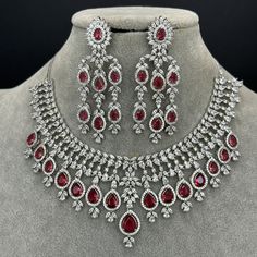 Ruby CZ diamond bridal necklace, American Diamond wedding necklace, Cz jewelry, Indian, Pakistani, and Punjabi wedding jewelry Regular Size And Adjustable with rhodium finish Ships from California, USA Delivery in 2-5 business days in the USA. Other colors can be found here https://www.etsy.com/listing/1423097794/sapphire-cz-diamond-bridal-necklace?ref=listings_manager_grid https://www.etsy.com/listing/1423095388/emerald-cz-diamond-bridal-necklace?ref=listings_manager_grid Color, shades, and texture displayed may slightly vary from the actual product due to digital image limitations. We request you consider these minor variations. Please expect the possibility of some slight imperfections when buying handmade jewelry. Please let me know if you have any questions. Arrives in a gift box. Tha Red Diamond Necklace For Wedding, Fine Jewelry Red Diamond Necklace For Weddings, Red Bridal Necklace With Sparkling Stones For Wedding, Red Crystal Bridal Necklace With Diamond Accents, Red Brilliant Cut Diamond Necklace For Wedding, Red Diamond Accented Necklaces For Wedding, Red Cubic Zirconia Diamond Necklace For Wedding, Fine Red Necklace For Wedding, Red Fine Jewelry Necklace For Wedding