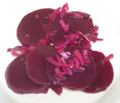 sliced beets in a white bowl on a table