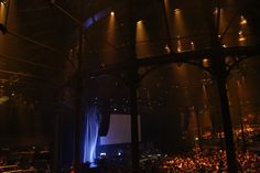 an auditorium full of people watching a movie