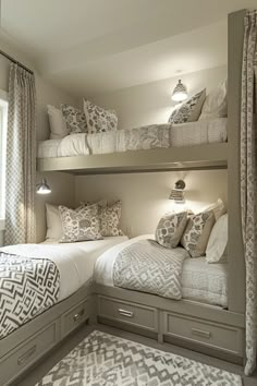 two bunk beds in a bedroom with white and gray decor