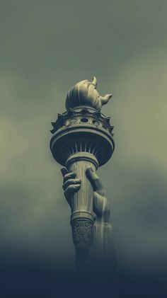 a tall statue with a clock on it's face in the middle of a foggy sky