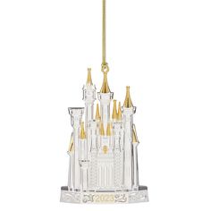 a glass ornament with a castle on it's side and gold spires