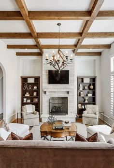 a living room filled with furniture and a flat screen tv mounted on the wall above a fireplace