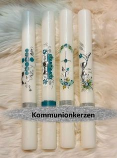 four white candles sitting on top of a fur covered floor next to an animal rug