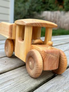 a wooden toy truck sitting on top of a wooden table