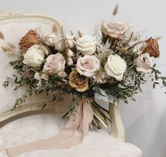 a bouquet of flowers sitting on top of a white chair