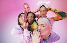 a group of women standing next to each other in front of a pink background with the words girlfriends on it