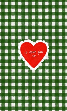 a green and white checkered table cloth with a red heart in the center that says i love you no