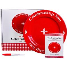 a red and white table setting with the words celebrating you written on it, along with two plates