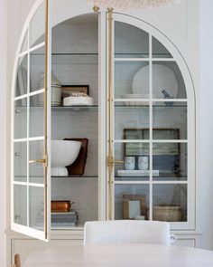 a white dining room table and some shelves