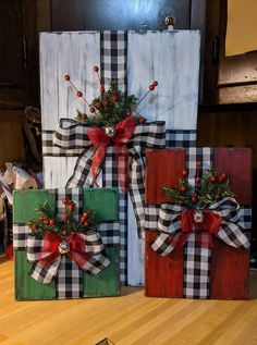 three wooden boxes decorated with christmas decorations