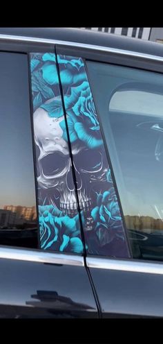 a car with a skull and roses on it's side window sticker in blue