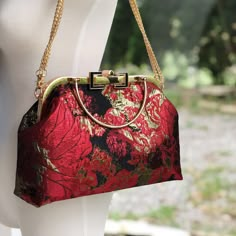 Our red lotus bag features a beautiful lotus flower pattern in different shades of red with a comfortable and beautiful hand clasp and chain. The interior liner is a soft pink color with a helpful pocket. ----------------------------------------------- Product name / Lotus Pond Color / Shades of Red lotus flowers. Fabric / Brocade Capacity / Day to day items (phone, wallet, keys, lipstick, makeup bag etc.) Function / hand held, crossbody, wrist Size / Clasp frame 26.5cm* Length30cm X height 21cm Red Evening Bag With Detachable Handle As Gift, Red Evening Bag With Top Handle For Gift, Red Top Handle Evening Bag As Gift, Red Top Handle Evening Bag For Gifts, Red Clutch Evening Bag With Detachable Handle, Red Evening Clutch With Detachable Handle, Elegant Red Shoulder Bag For Gift, Elegant Red Handheld Clutch, Red Rectangular Evening Bag For Festive Occasions