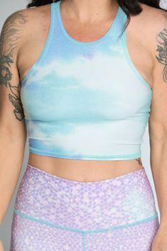 The Teeki Mermaid Tanks are cut with a high neckline and razor back crop top. They can be layered and offer gentle compression for low-impact workouts, yoga, swimming, and everyday layering. Fit: The single layer of lightweight fabric offers a gentle compression for low impact activities and daily use. Move freely in yoga class, by the pool, in the ocean, or layering without the discomfort of tight elastic bands, thick materials and underwires. If you have a small chest size the fit may not be t We Love The Earth, Mermaid Tank, Recycled Water Bottles, Yoga Crop Tops, Love The Earth, Eco Friendly Clothing, Low Impact Workout, Yoga Fashion, Best Leggings