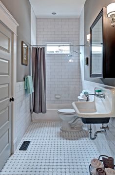 a bathroom with a toilet, sink and shower