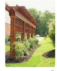 an image of a wooden structure on the side of a building that has plants growing in it