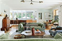 a living room filled with furniture and lots of windows